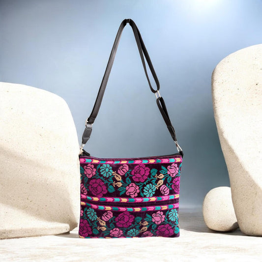 Front of the Banafsaj Crossbody showing floral Palestinian Tatreez, zipper closure and extended black strap.
