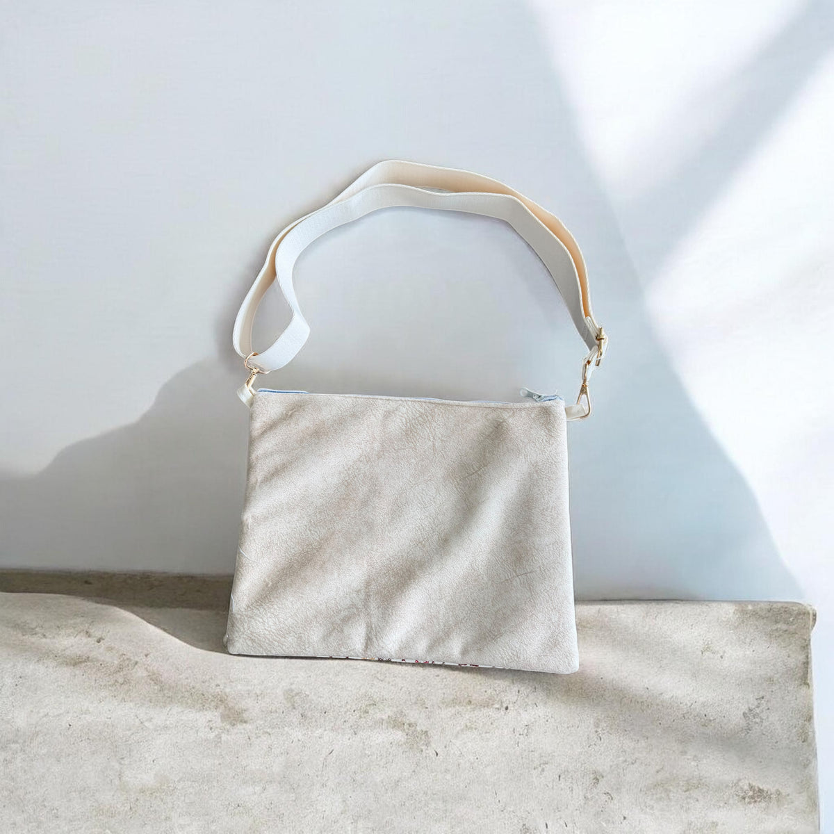 Cream velvet back of Cypress Tatreez Crossbody with cream adjustable strap and gold clasps