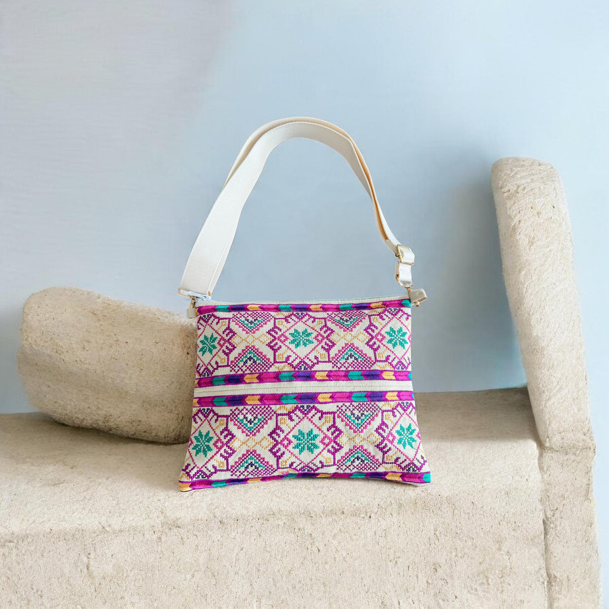 Najmeh Crossbody in purple, with pink and green tatreez embroidery on the front and a cream adjustable strap