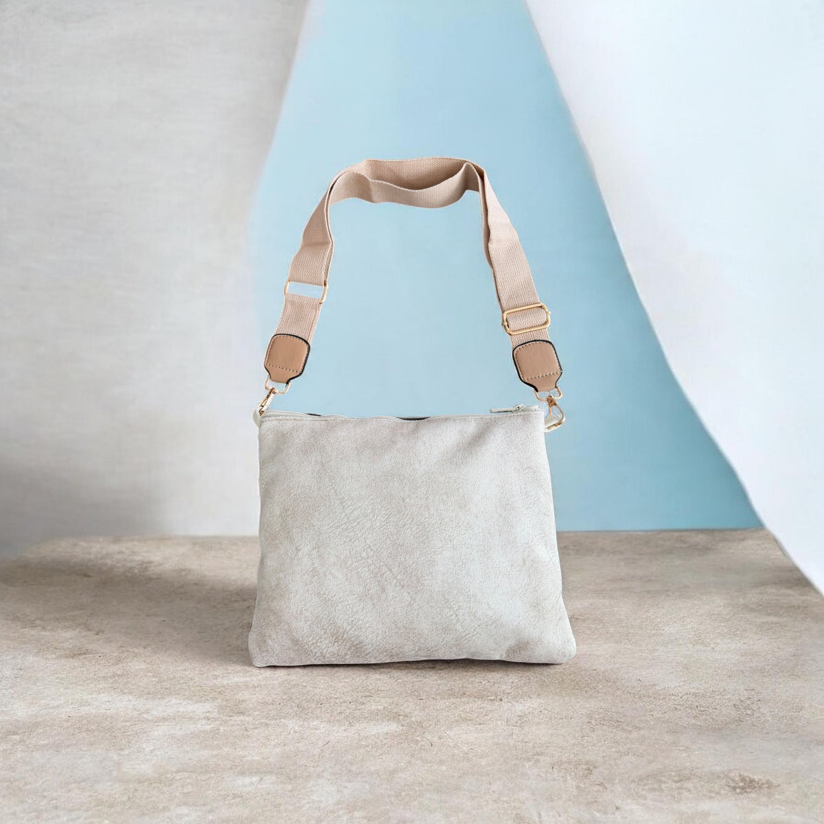 Back of the green Najmeh Crossbody showing its plain cream velvet backing and taupe strap