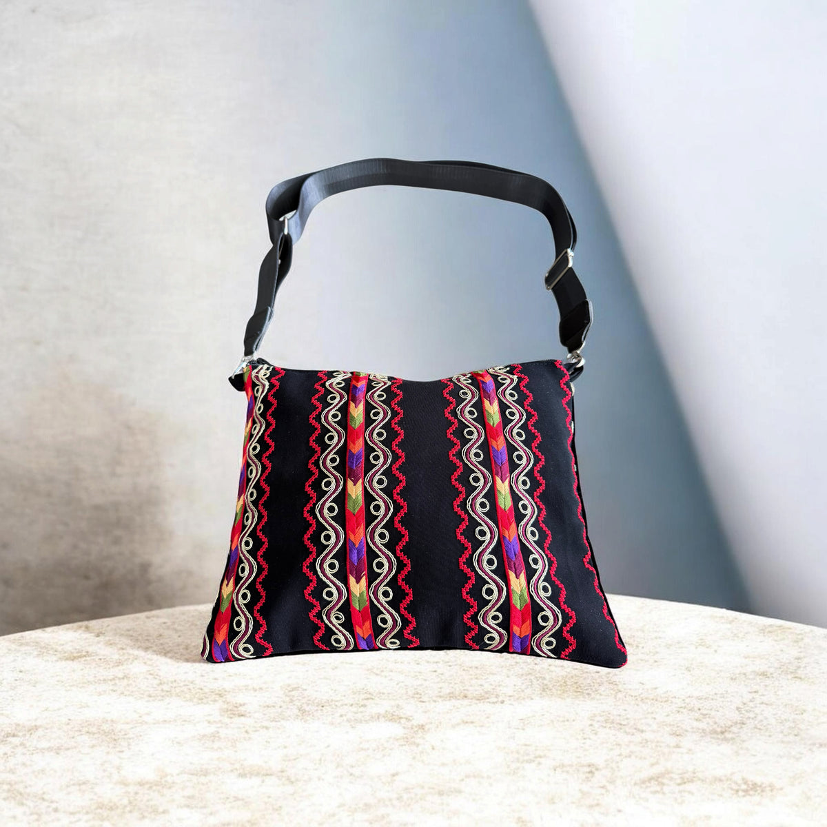 Sinsal Crossbody with vertical multicolor bands, cream scroll embroidery, and red zigzag detailing.